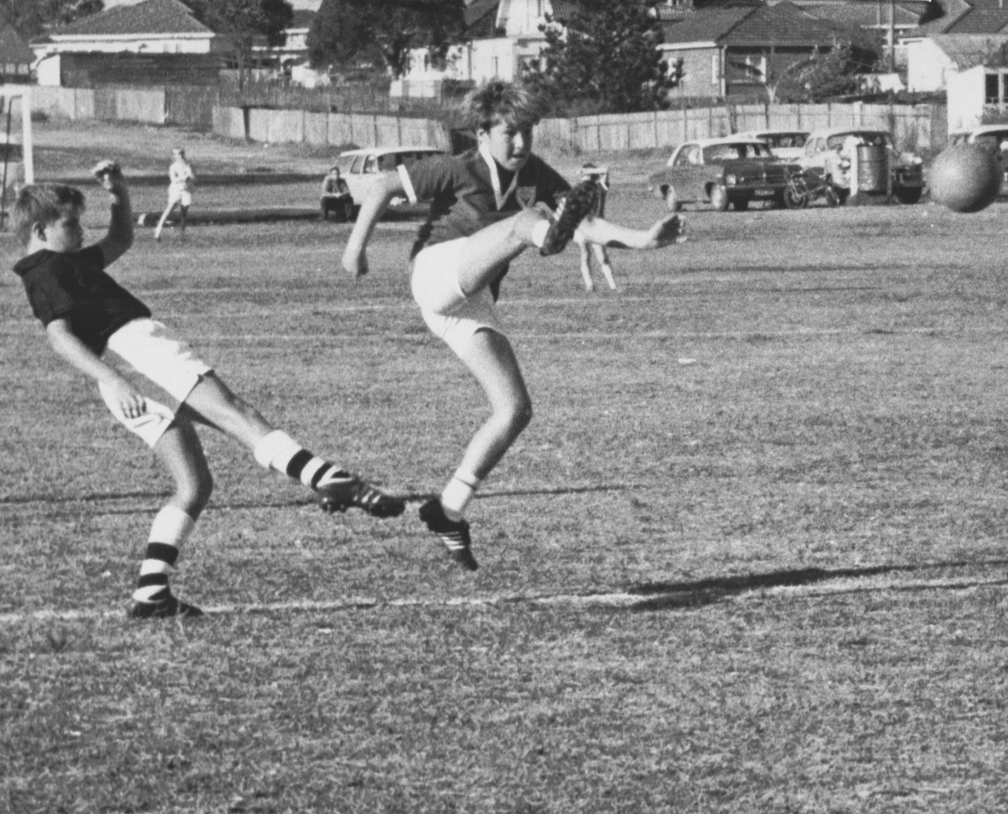 Black and white photo of two boys playing soccer