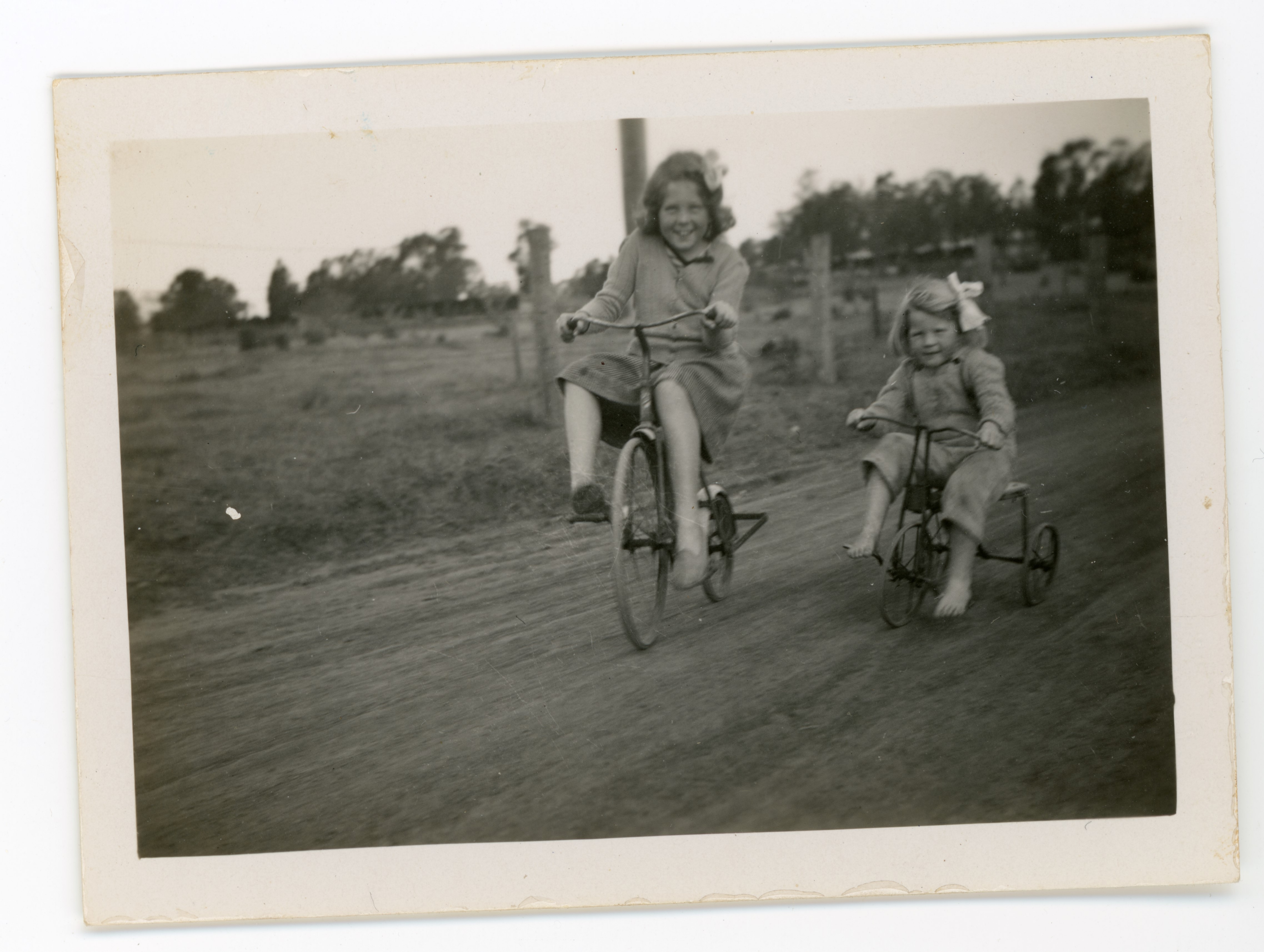 Sisters Phillips riding bicycles down West Street